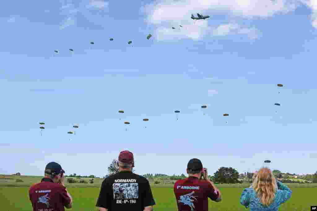 Paratroopers are dropped over the Normandy countryside, near Ranville in western France, as part of the commemoration of the 70th anniversary of D-Day, June 5, 2014.