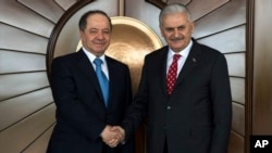 Turkey's Prime Minister Binali Yildirim, right, shakes hands with Iraqi Kurdish leader Massoud Barzani, in Ankara, Turkey, Feb. 27, 2017.