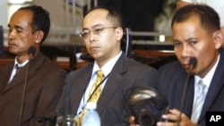 U.N.-assisted tribunal's judges, Motoo Noguchi, center, Japanese, sits between Cambodian, Sim Rith, left, and Ya Narin, right, during a meeting in Phnom Penh, file photo. 