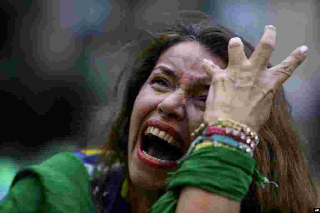 A Brazil soccer fan cries as Germany scores against her team at a World Cup semifinal match as she watches the game on a live telecast in Belo Horizonte, Brazil, July 8, 2014.