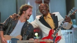 Bruce Springsteen and Chuck Berry during the performance of "Johnny B. Goode" at a concert for the Rock and Roll Hall of Fame in Cleveland, Ohio, in 1995