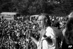 In this Jan. 14, 1967 photo, Timothy Leary addresses a crowd of hippies at the "Human Be-In" that he helped organize in Golden Gate Park, San Francisco, Calif. Leary told the crowd to "Turn on, Tune in and Drop out".