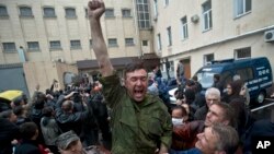 A man cheers after being released from a local police station after it was stormed by pro-Russian protesters in Odessa, Ukraine, on May 4, 2014. 
