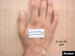 A measurement strip lies on the hand of a detainee in an undated photo from Iraq's Abu Ghraib prison, among 198 images released in a Freedom of Information Act lawsuit against the U.S. Department of Defense in Washington, D.C., Feb. 5, 2016.