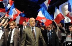 FILE - French Foreign Minister Alain Juppe (C) arrives at a meeting in Bordeaux, western France, March 3, 2012.
