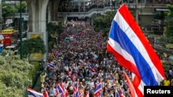 Demonstran anti-pemerintah berpawai di kawasan bisnis kota Bangkok, Kamis (19/12).