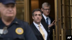 President Donald Trump's former attorney Michael Cohen (C) leaves Federal court, Aug. 21, 2018, in New York. 