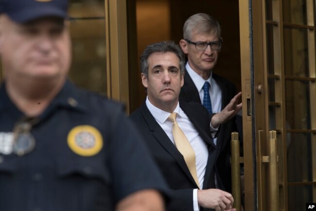 President Donald Trump's former attorney Michael Cohen (C) leaves Federal court, Aug. 21, 2018, in New York.