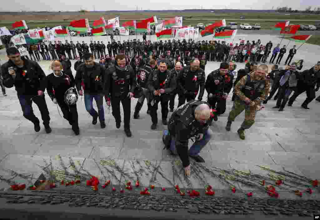 A group of Russian bikers lay flowers at Hill of Glory memorial complex on the outskirts of Minsk, Belarus.