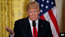 U.S. President Donald Trump speaks during a news conference in the East Room of the White House, Jan. 10, 2018, in Washington. 