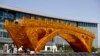 Workers install wires on a Golden Bridge of Silk Road structure outside the National Convention Center, the venue for the Belt and Road Forum for International Cooperation, in Beijing, April 18, 2017. Starting Sunday, Vladmir Putin of Russia, Recep Tayyip Erdogan of Turkey and Spain's Mariano Rajoy are among those attending a summit to discuss Xi's "One Belt, One Road" infrastructure investment program to stitch together the Eurasian continent.