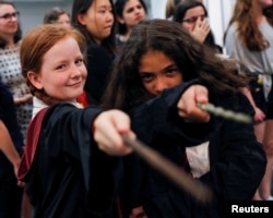 Harry Potter fans pose for a photograph at an anniversary presentation at Waterstones bookshop in London, Britain, June 26, 2017.