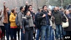 FILE - University students and academics react toward Turkish policemen at the Cebeci campus of Ankara University during a protest in Ankara, Feb. 10, 2017, against the dismissal of academics from universities following a post-coup emergency decree.
