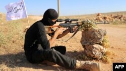 FILE - A rebel fighter from the "First Battalion" under the Free Syrian Army takes part in a military training in the rebel-held countryside of the northern city of Aleppo, June 10, 2015.