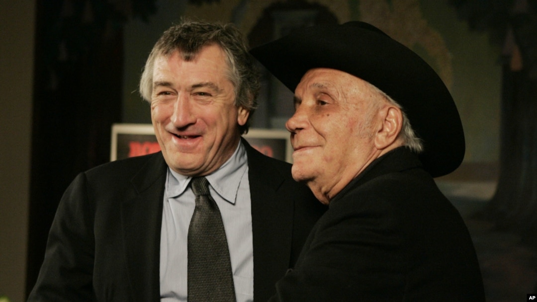 FILE - Jake LaMotta, right, and actor Robert DeNiro stand for photographers before watching a 25th anniversary screening of the movie "Raging Bull" in New York, Jan. 27, 2005.