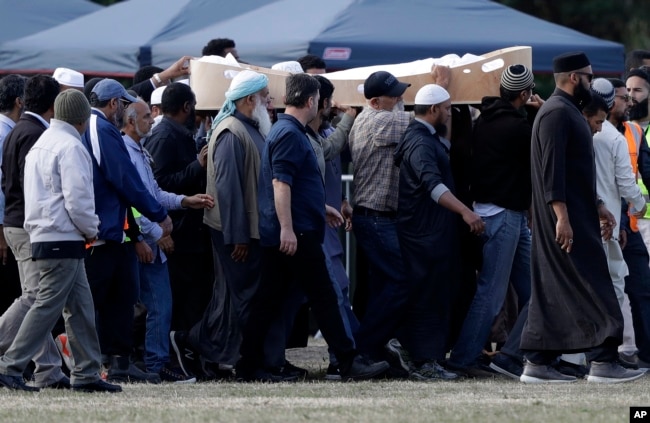 Mourners carry the body of a victim of the March 15 mosque shootings for burial at the Memorial Park Cemetery in Christchurch, New Zealand, March 20, 2019.