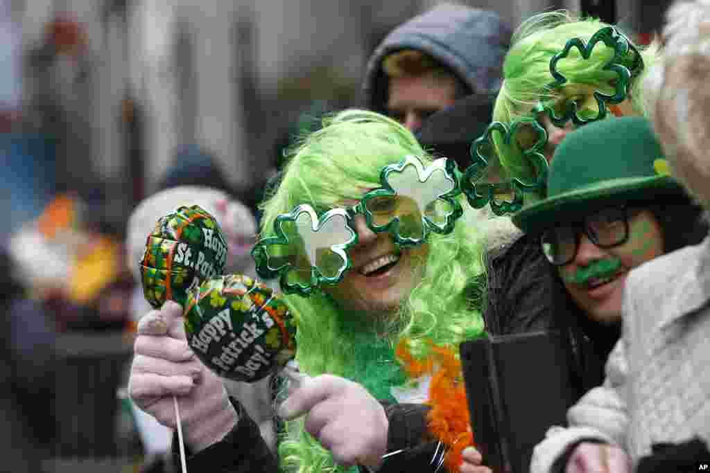 People stand along New York City&rsquo;s 5th Avenue during the St. Patrick&#39;s Day parade on March 17. 