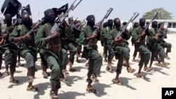 FILE - Hundreds of newly trained al-Shabab fighters perform military exercises in the Lafofe area 18 km south of Mogadishu, Somalia, Feb. 17, 2017. 