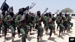 FILE - Hundreds of newly trained al-Shabab fighters perform military exercises in the Lafofe area 18 km south of Mogadishu, Somalia, Feb. 17, 2017. 