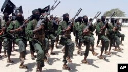 FILE - Hundreds of newly trained al-Shabab fighters perform military exercises in the Lafofe area 18 km south of Mogadishu, Somalia, Feb. 17, 2017. 