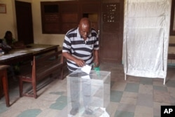 A man cast his ballot at a polling station, in Brazzaville, Congo. Republic of Congo's president, who has ruled the Central African country for more than 30 years, March 20, 2016.