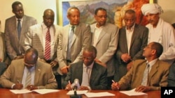 Representatives from North and South Sudan reach landmark agreement outlining the status of the disputed Abyei border region, with signators seated at table, from left to right, are Secretary-General of the SPLM, Pagan Amoum, former South African Presiden