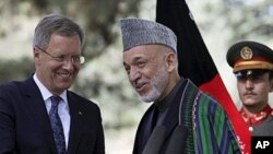 Afghan President Hamid Karzai (C) talks with German President Christian Wulff following a joint press conference in Kabul, Afghanistan, October 16, 2011.