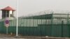 FILE - A guard tower and barbed wire fences are seen around a facility in the Kunshan Industrial Park in Artux in western China's Xinjiang region. This is one of a growing number of internment camps in the Xinjiang region.