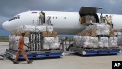 FILE - Freight is being offloaded from a plane at Mogadishu airport, in Mogadishu, Somalia, Aug. 8, 2011.