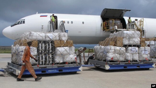FILE - Freight is being offloaded from a plane at Mogadishu airport, in Mogadishu, Somalia, Aug. 8, 2011.