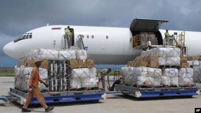 FILE - Freight is being offloaded from a plane at Mogadishu airport, in Mogadishu, Somalia, Aug. 8, 2011. Somalia is embroiled in a standoff over the confiscation from UAE diplomats at Mogadishu airport of nearly $10 million in cash whose purpose remains in dispute.