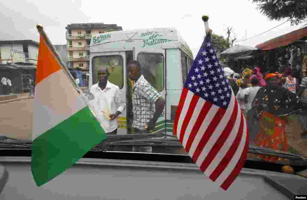 The U.S. and Ivory Coast national flags are displayed in a public bus station station, in Abidjan, Ivory Coast, Aug. 3, 2014.