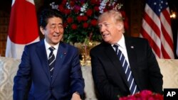 President Donald Trump and Japanese Prime Minister Shinzo Abe smile during their meeting at Trump's private Mar-a-Lago resort, April 17, 2018, in Palm Beach, Fla.
