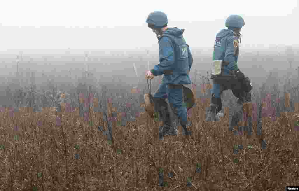 Members of the Emergencies Ministry of the separatist Donetsk People&#39;s Republic demine the area near the settlement of Petrovskoye (Petrivske) in Donetsk region, Ukraine, Nov. 19, 2019.