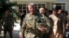 FILE - U.S. Army General John Nicholson, commander of Resolute Support forces and U.S. forces in Afghanistan, walks with Afghan officials during an official visit in Farah province, Afghanistan, May 19, 2018. 