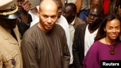 Karim Wade, second from left, and Sindiely Wade, right, children of Senegal's President Abdoulaye Wade, presidential elections, Dakar, February 26, 2012.
