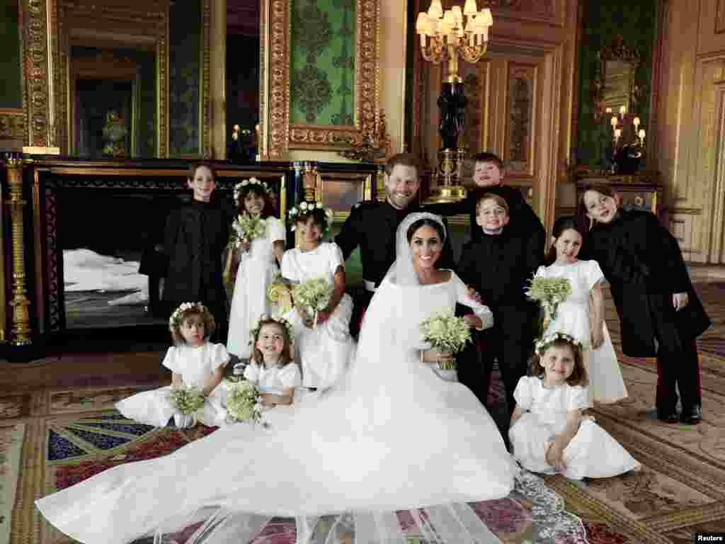 This official wedding photograph released by the Duke and Duchess of Sussex shows The Duke and Duchess in The Green Drawing Room, Windsor Castle, with (left-to-right): Back row: Master Brian Mulroney, Miss Remi Litt, Miss Rylan Litt, Master Jasper Dyer, Prince George, Miss Ivy Mulroney, Master John Mulroney. Front row: Miss Zalie Warren, Princess Charlotte, Miss Florence van Cutsem, May 19, 2018.