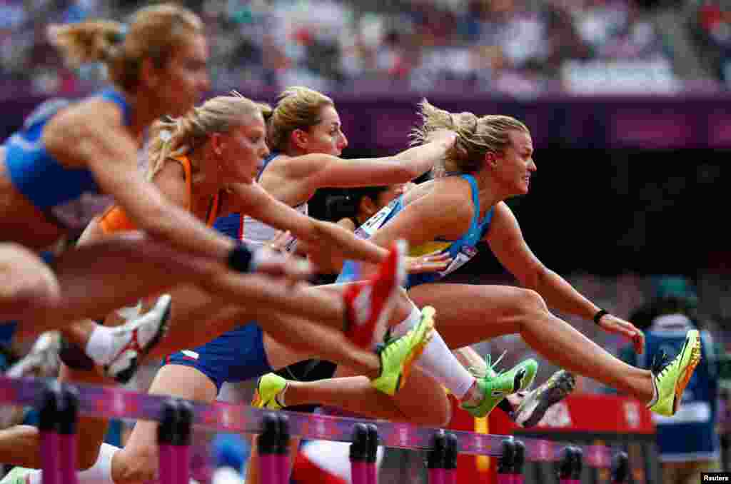 Natallia Dobrynska (R) of Ukraine, leads the field as she competes in her women's heptathlon 100m hurdles heat. 