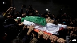 Palestinians carry the body of Tamir Abu al-Khair, 17, who was shot and killed on Saturday by Israeli troops during a protest next to the Israeli border, eastern Gaza Strip, out of the family home during his funeral in Gaza City, Sunday, March 31, 2019.