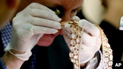 Christie's auction house appraiser David Warren examines a set of jewelry from Roumeliotes Collection, one of three sets of the Marcos Jewelry Collection, during appraisal at the Central Bank of the Philippines, Nov. 24, 2015 in Manila, Philippines. 