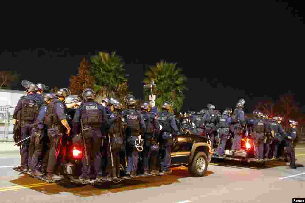 Police follow protesters during a march in Los Angeles, California, following Monday's grand jury decision in the shooting of Michael Brown in Ferguson, Missouri.