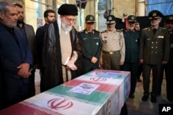 FILE - In this photo released by the official website of the office of Iran's supreme leader, Ayatollah Ali Khamenei attends the state funeral of Mohsen Hojaji, a young Revolutionary Guard soldier how was beheaded in Syria by the Islamic State group, in Tehran, Iran, Sept. 27, 2017.