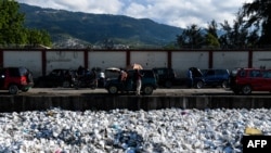 Plastic waste is seen floating on a sewage canal in the Haitian capital Port-au-Prince, on April 23, 2019.