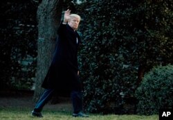 President Donald Trump waves as he arrives at the White House in Washington, March 5, 2017, from a trip to Florida.