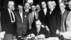 President Franklin Roosevelt signs a law creating the Tennessee Valley Authority on May 18, 1933. He envisioned "a corporation clothed with the power of government but possessed of the flexibility and initiative of private enterprise."