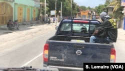 Cars are stopped on the road at Gressiers, Haiti.