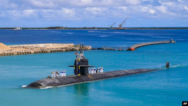 FILE - In this photo provided by US Navy, the submarine USS Oklahoma City returns to a US naval base in Guam, Aug. 19, 2021.