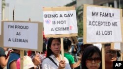 FILE - Indonesian gay activists hold posters during a protest demanding equality for LGBT (Lesbian, gay, bisexual and transgender) people in Jakarta, Indonesia, May 21, 2011.