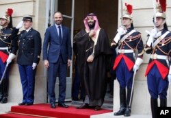 FILE - Saudi Arabia Crown Prince Mohammed bin Salman, center, is welcomed by French Prime Minister Edouard Philippe, second left, in Paris, April 9, 2018.