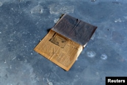 A Komsomolskaya Pravda newspaper dating from 1988 lies on the floor in a building that was once apartments where Russian doctors and soldiers lived with their families, at a former Soviet military hospital, which lies derelict since 1991 when the last Russian troops left Hungary, in Budapest, Hungary, May 15, 2017.